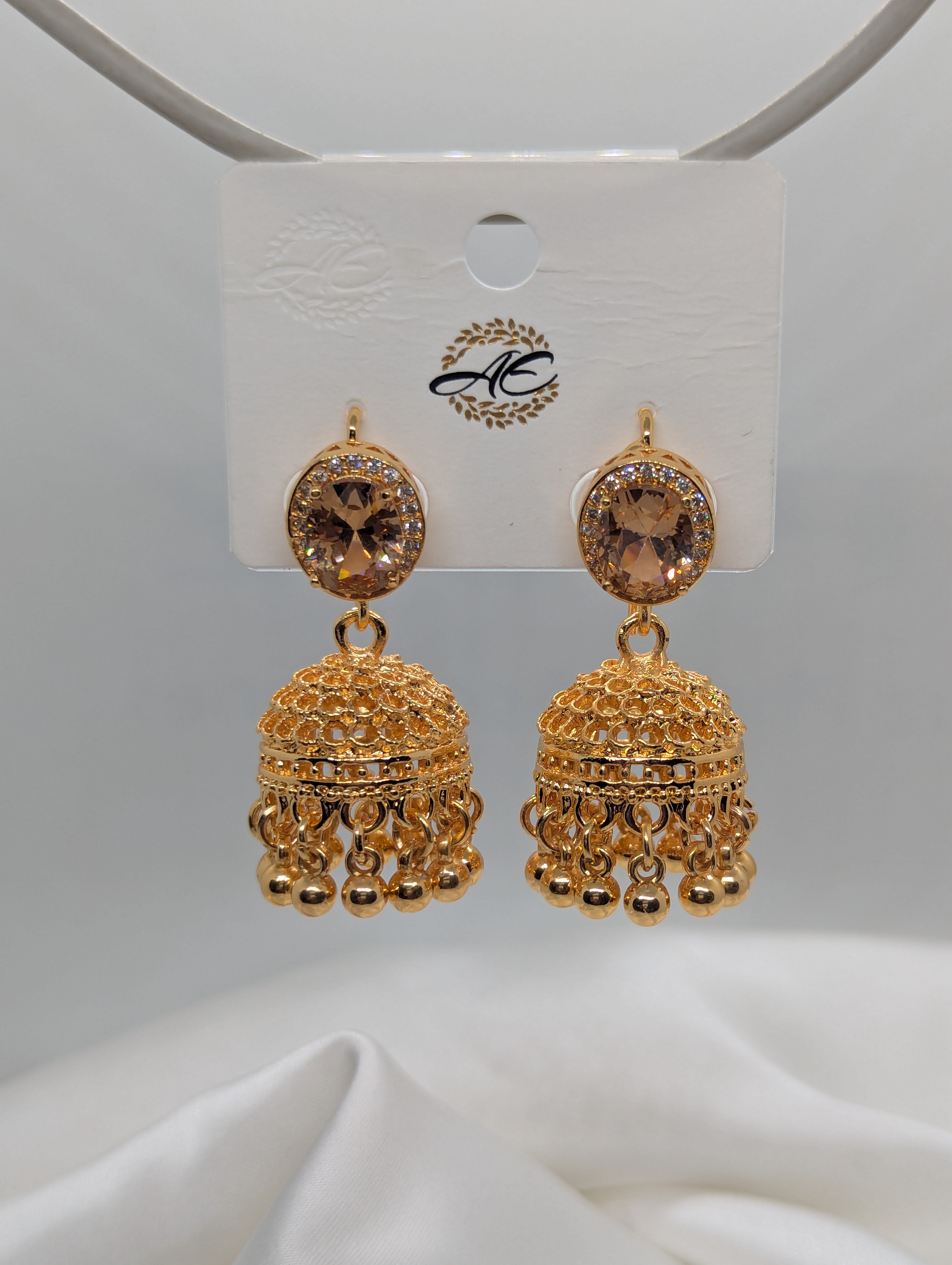Elegant Gold-Plated Jhumka Earrings with Champagne Stones and Filigree Detail