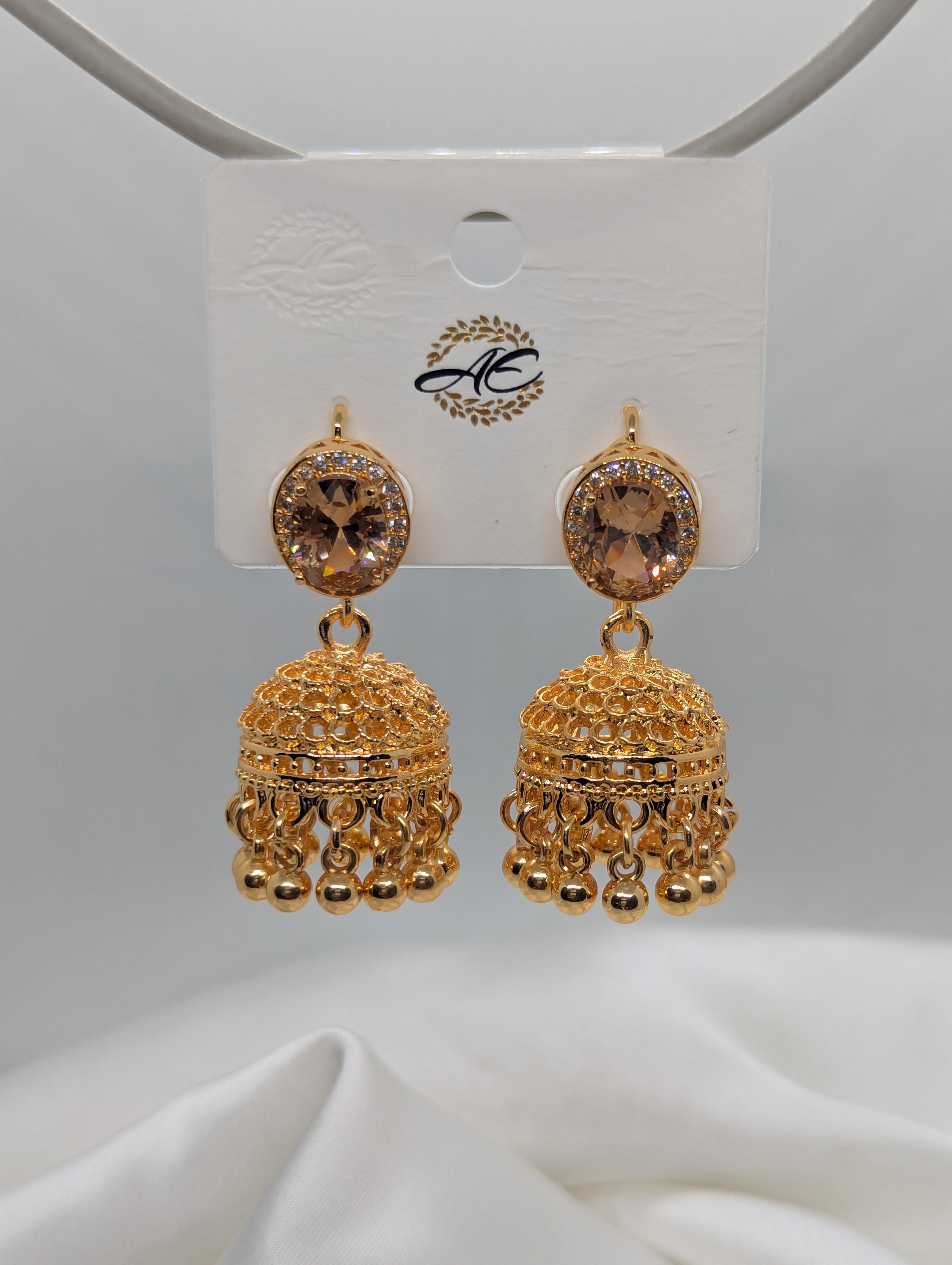 Elegant Gold-Plated Jhumka Earrings with Champagne Stones and Filigree Detail