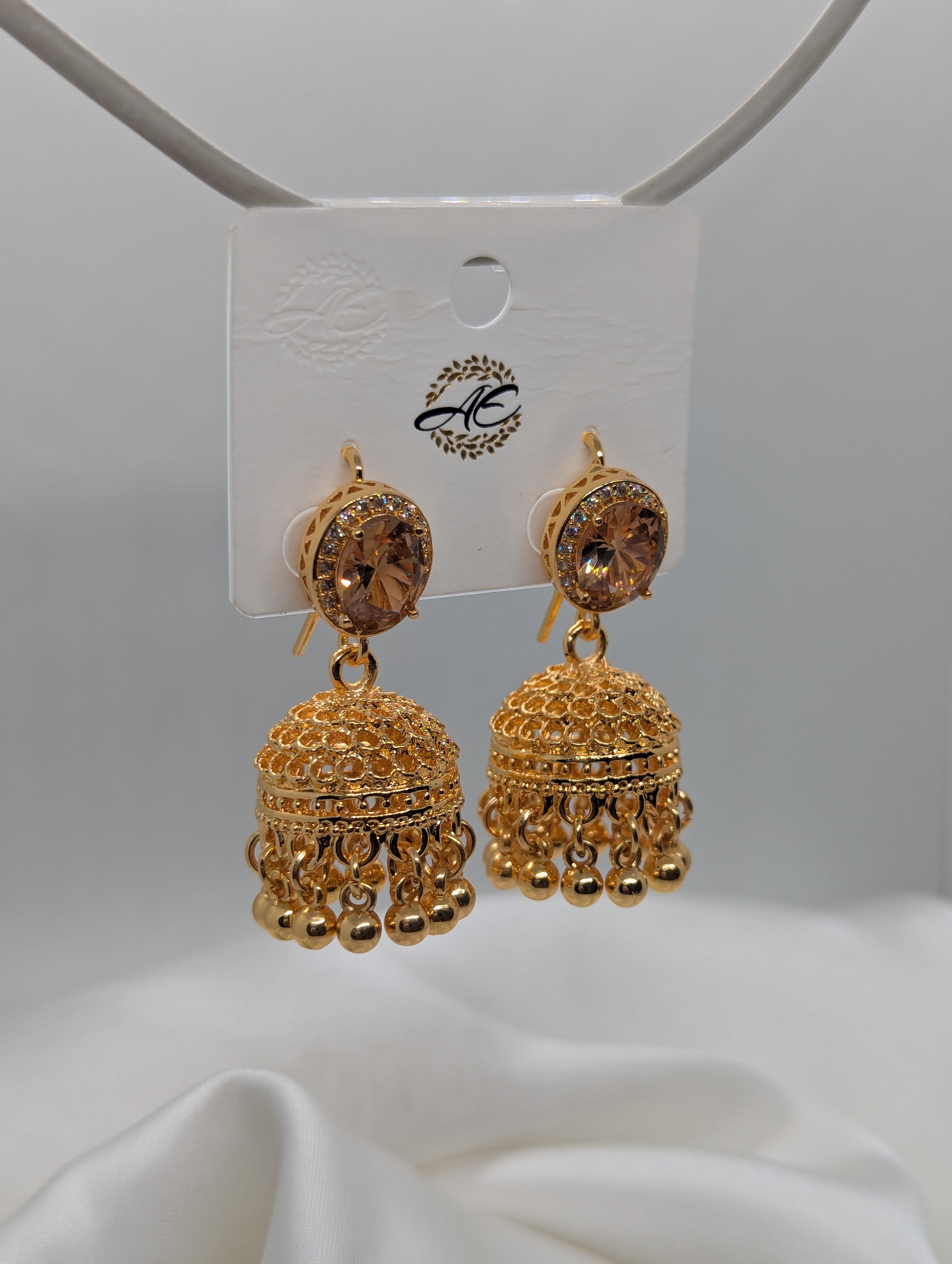 Elegant Gold-Plated Jhumka Earrings with Champagne Stones and Filigree Detail